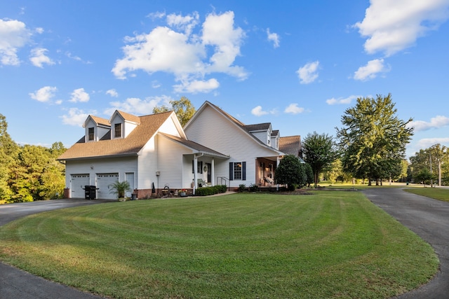 cape cod home featuring a front yard and a garage