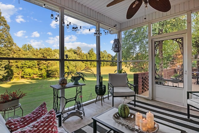 sunroom / solarium featuring ceiling fan