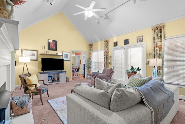 carpeted living room featuring ornamental molding, track lighting, high vaulted ceiling, and ceiling fan