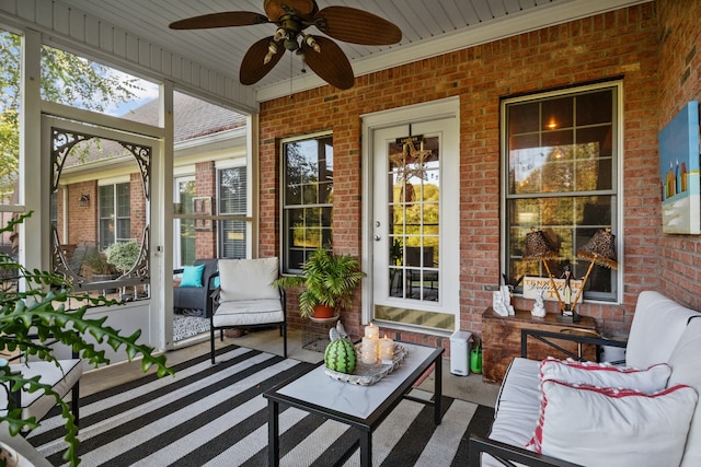 sunroom / solarium featuring ceiling fan