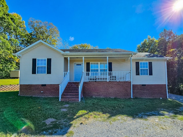 view of front facade with a front yard and covered porch