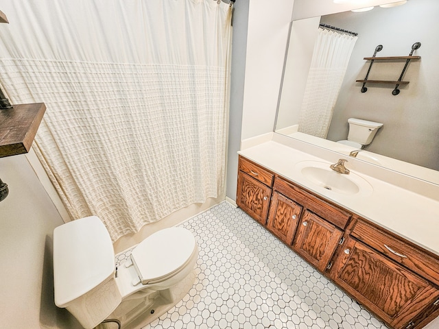 bathroom with vanity, curtained shower, and toilet