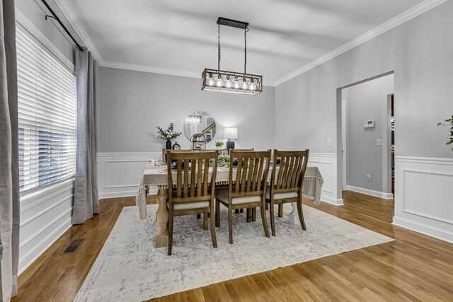 dining space with crown molding and dark hardwood / wood-style flooring