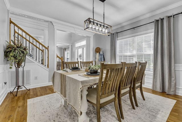 dining area featuring ornamental molding and hardwood / wood-style floors