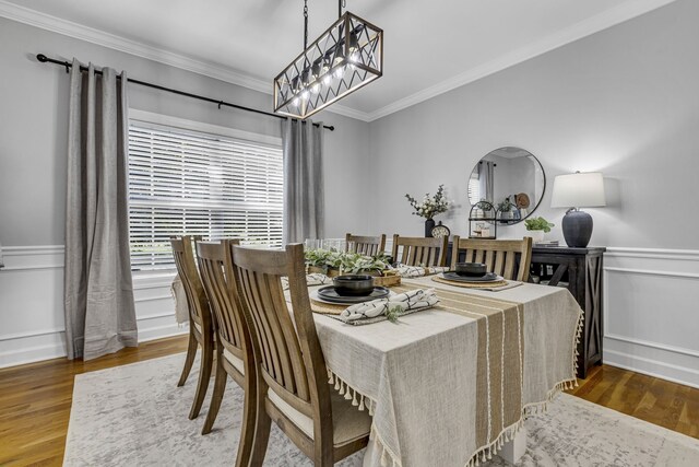 dining space featuring wood-type flooring and ornamental molding