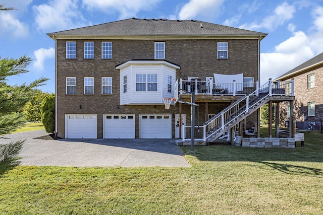 back of house with a wooden deck, a garage, and a lawn