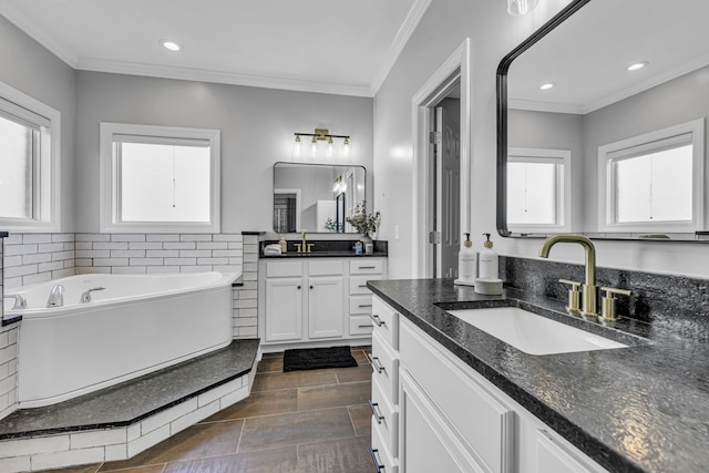 bathroom with vanity, a tub to relax in, and ornamental molding