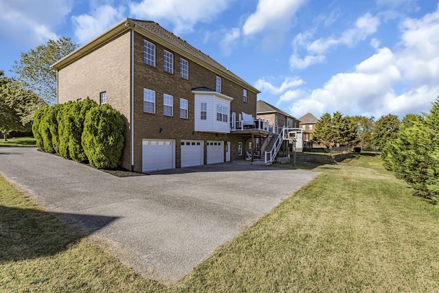 back of property featuring a yard and a garage