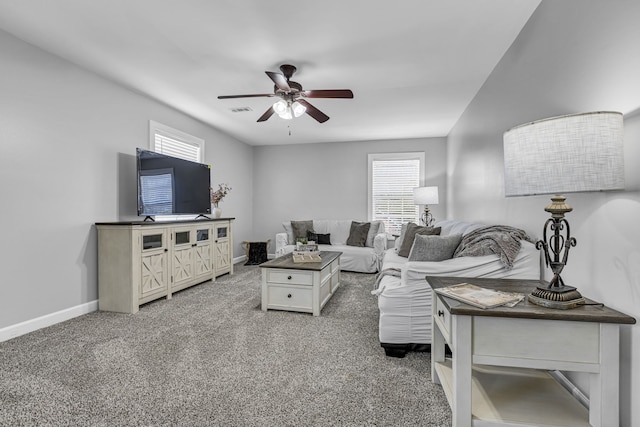 living room featuring carpet, plenty of natural light, and ceiling fan