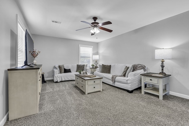 living room featuring carpet floors and ceiling fan