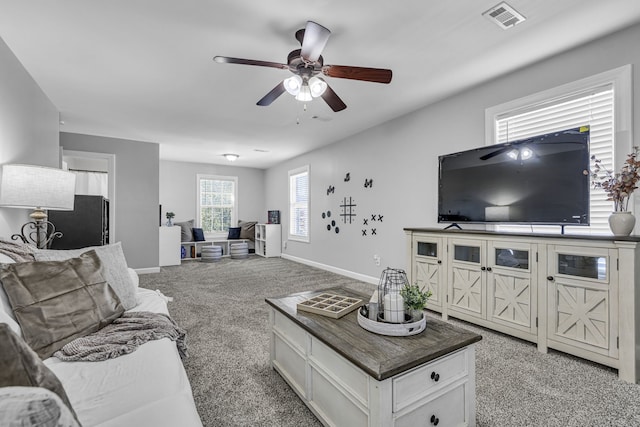 living room with light colored carpet and ceiling fan