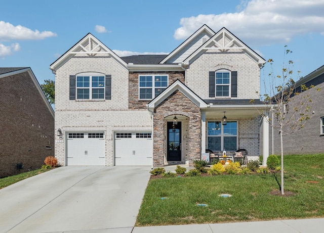 view of front of property featuring a garage, a front lawn, and a porch