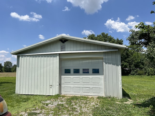 garage featuring a lawn