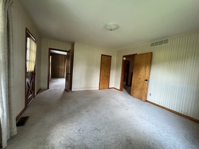 unfurnished room with light carpet