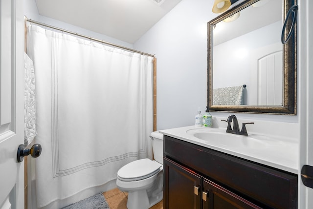 bathroom featuring vanity, toilet, and tile patterned flooring