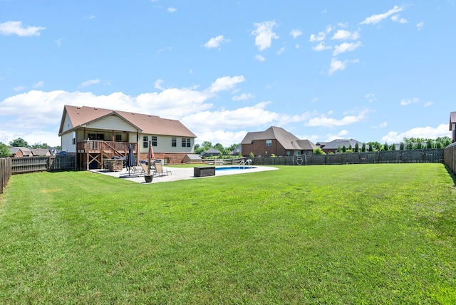 view of yard with a fenced in pool and a patio