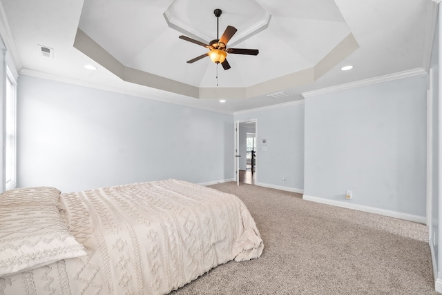 bedroom with ornamental molding, a tray ceiling, and ceiling fan