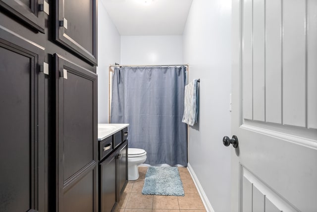 bathroom with vanity, toilet, curtained shower, and tile patterned flooring