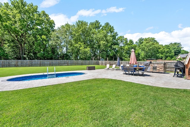 view of swimming pool with a yard and a patio area