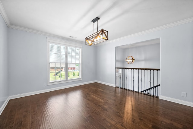 spare room featuring a notable chandelier, crown molding, and dark hardwood / wood-style flooring