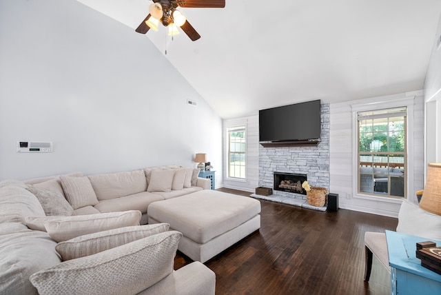 living room featuring a stone fireplace, ceiling fan, high vaulted ceiling, and dark hardwood / wood-style flooring