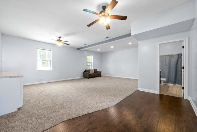 interior space featuring ceiling fan, plenty of natural light, and dark hardwood / wood-style floors