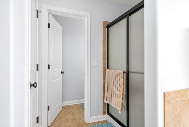 bathroom with walk in shower and tile patterned flooring