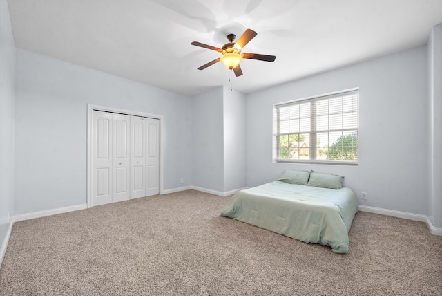 carpeted bedroom with a closet and ceiling fan