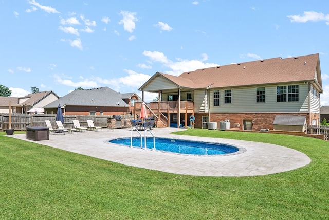 view of swimming pool with central AC, a yard, an outdoor fire pit, a patio area, and a deck