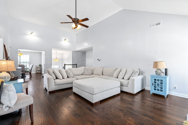 living room featuring dark hardwood / wood-style floors and high vaulted ceiling