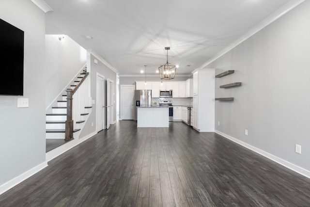 unfurnished living room with crown molding, dark hardwood / wood-style floors, and a chandelier