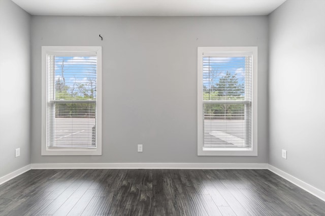 unfurnished room with dark hardwood / wood-style floors