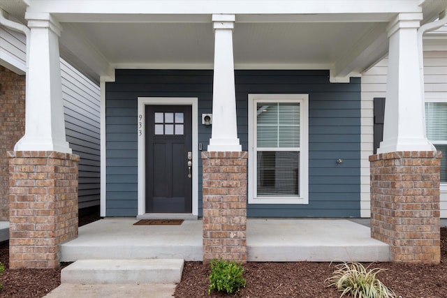 entrance to property featuring a porch