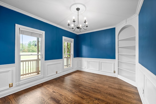 unfurnished dining area with crown molding, a chandelier, dark hardwood / wood-style floors, and built in shelves