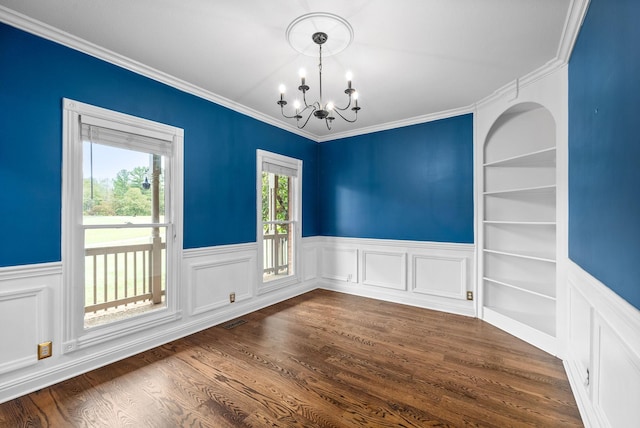 2264 Lock B Rd N, Clarksville, TN 37043 - empty room featuring a chandelier, a wainscoted wall, built in features, dark wood finished floors, and ornamental molding