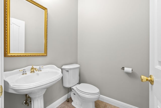 bathroom with toilet and tile patterned floors