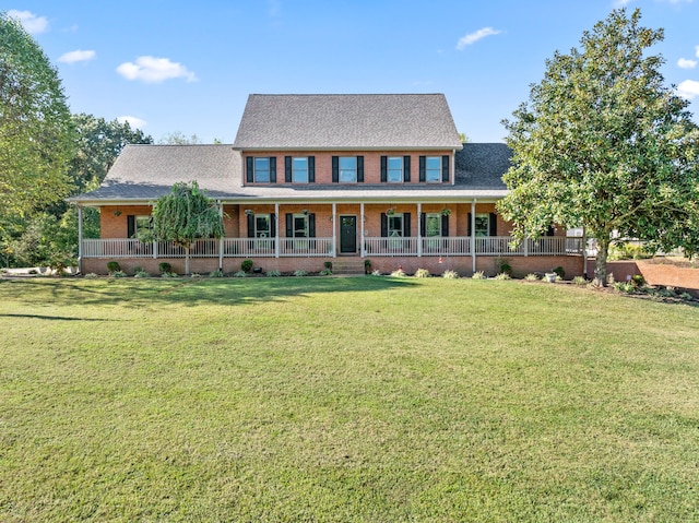 colonial-style house featuring a front lawn and a porch