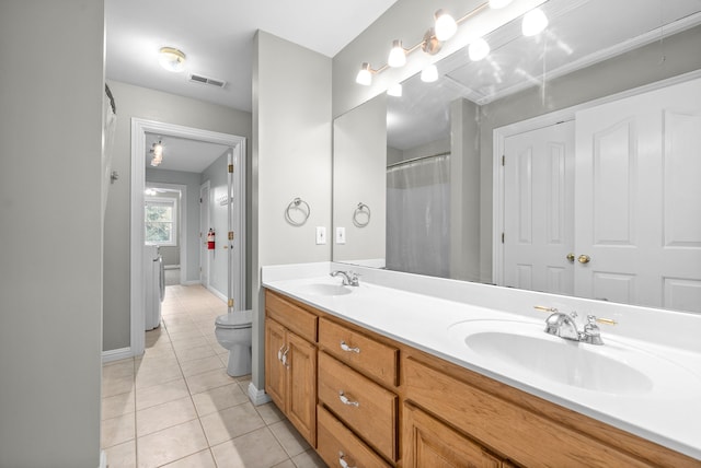 bathroom featuring vanity, toilet, and tile patterned flooring