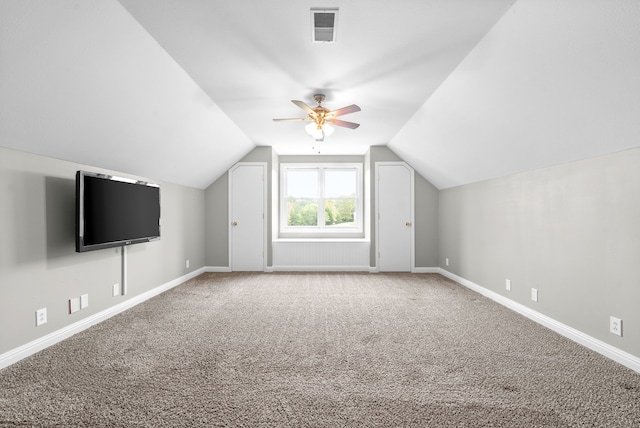 bonus room with ceiling fan, carpet flooring, and vaulted ceiling