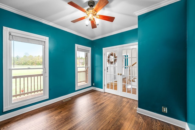 spare room featuring french doors, ceiling fan, crown molding, and dark hardwood / wood-style flooring