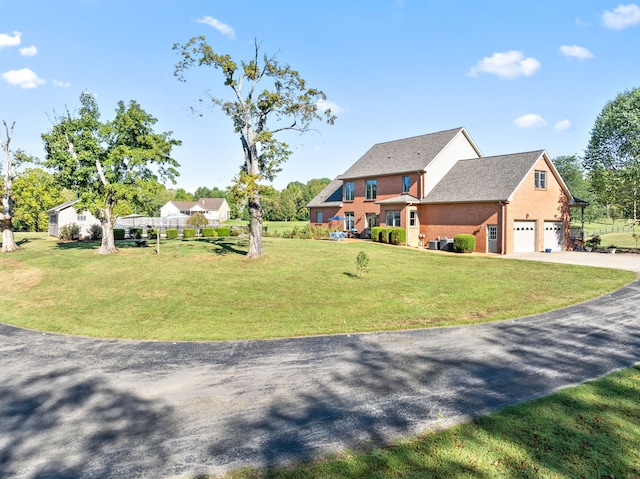 view of front of home with a front yard and a garage