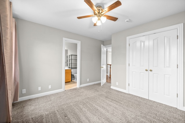 unfurnished bedroom featuring connected bathroom, light colored carpet, a closet, and ceiling fan