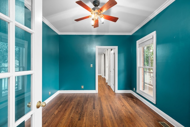 spare room featuring crown molding, dark hardwood / wood-style floors, and ceiling fan