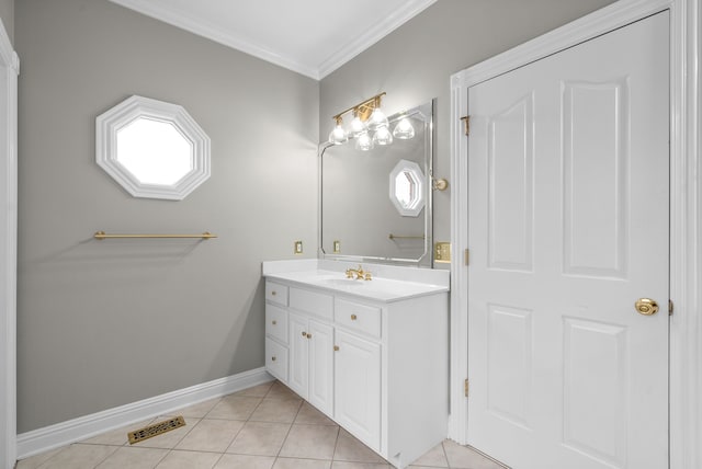 bathroom with vanity, tile patterned floors, ornamental molding, and a healthy amount of sunlight