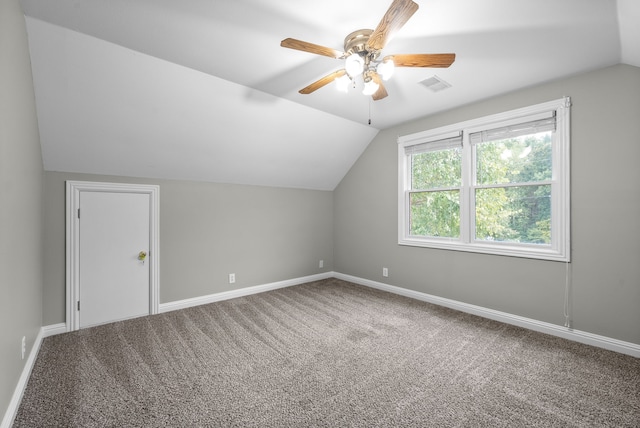 bonus room with ceiling fan, carpet flooring, and vaulted ceiling