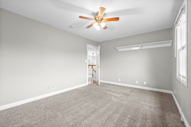 unfurnished room featuring ceiling fan and carpet flooring