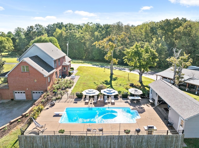 view of swimming pool with a yard, a diving board, and a patio