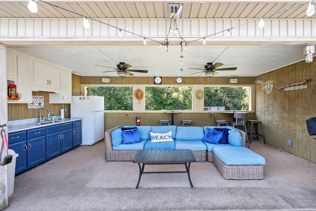 view of patio with ceiling fan and sink