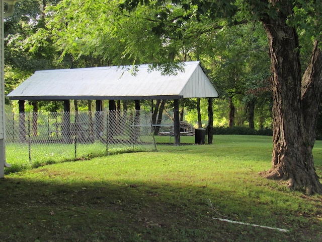 view of property's community featuring fence, a gazebo, and a lawn