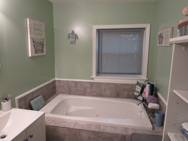 bathroom featuring vanity and tiled bath